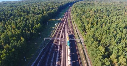 AERIAL railway: Long cargo train wagons station backward movement - 2 Stock Footage 80479096