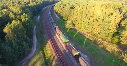 AERIAL railway: Long cargo train transporting wagons across the autumn forest -5 Stock Footage 80482848