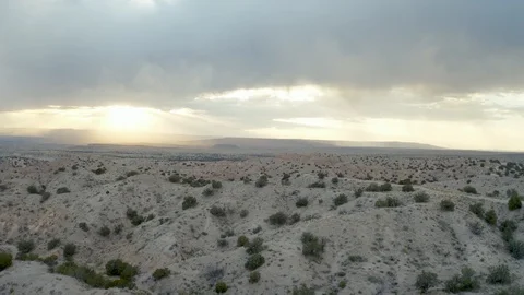 Aerial Into the rain clouds and golden sunset over New Mexico. Stock Footage