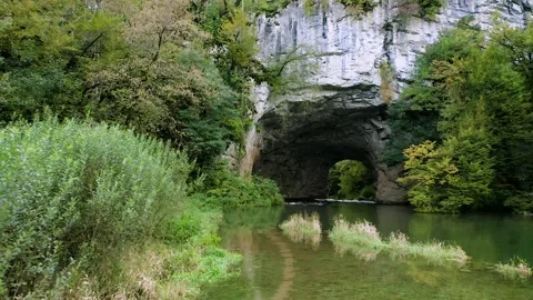 Aerial: Rak River Floating Under Big Natural Bridge In The Rakov Škocjan Valley Stock Footage 250268950