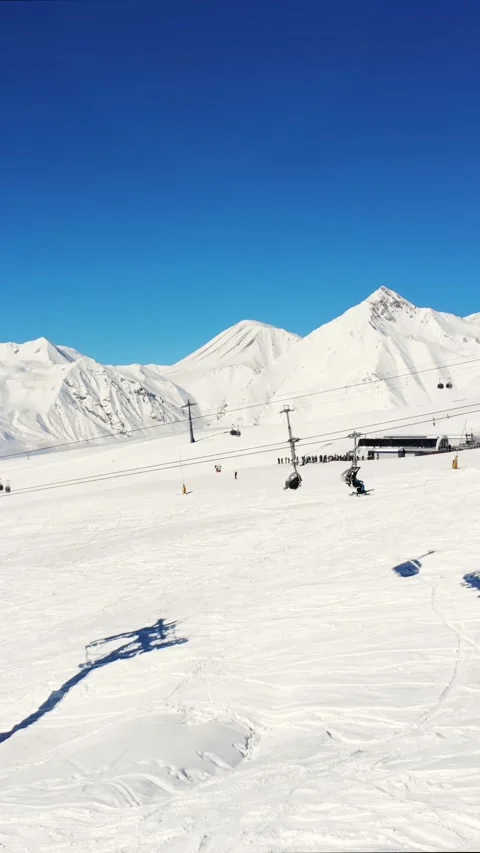 Aerial real time view of Gudauri ski resort with gondola cable lifts ascend.. Stock Footage 311640285