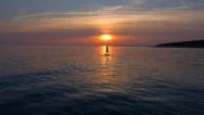 Aerial - Rear View Of A Man Stand Up Paddling At Sunset Stock Footage