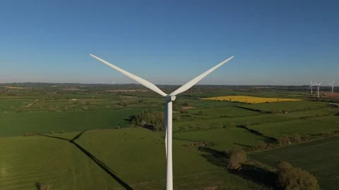 Aerial Rear View of Rotating Wind Turbine Over Countryside Stock-Footage 333936720