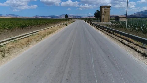 Aerial rearview of small remote-controlled aircraft taking off from public road Stock Footage 100783080