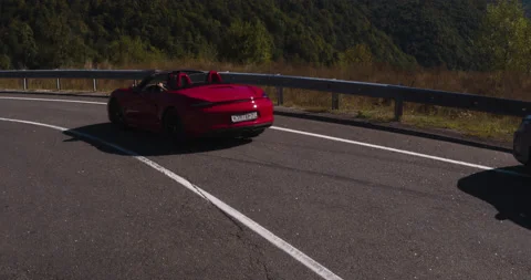 Aerial Red Open Car Moving Through Open Country Stock Footage 160278955