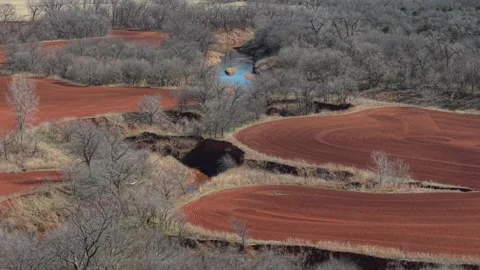 Aerial Red Soil Farm Fields with Creek and Winter Trees Oklahoma Stock Footage 329192151