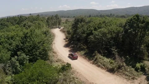 Aerial red suv car active track on off-road at forest Stock Footage 151342564