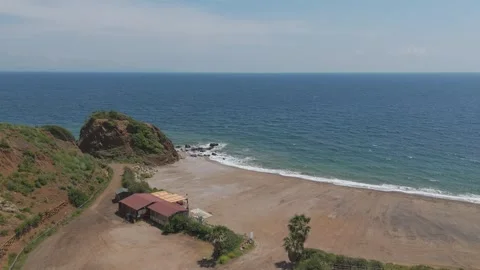 Aerial of Remote Beach with Red Sand and Clear Blue Water – 4K Drone Stock Footage 310179542