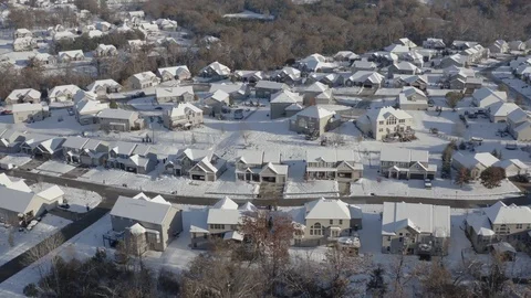Aerial of a residential neighborhood with homes covered in snow Stock Footage 111663243