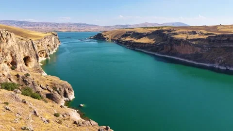 Aerial Reveal from Dramatic Canyon to Emerald River in Bright Sunlight 스톡 동영상 339801091
