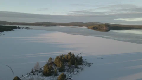 Aerial Reverse Circling Drone Shot Of Frozen Lake During Sunset Stock Footage 224296936