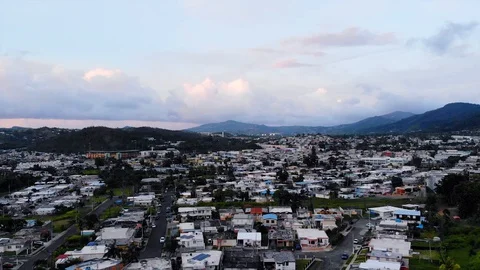 Aerial, reverse, drone shot over the Cayey town, dusk, in Puerto Rico, USA Vídeo Stock 128738948