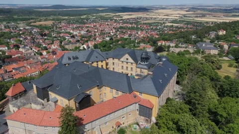 Aerial reverse establish of Blankenburg castle roofs above the red roofed town 動画素材 337979039