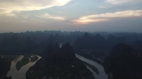 AERIAL REVERSE SHOT OF BEAUTIFUL SUNSET IN GUILIN CHINA Stock Footage 65404814