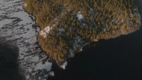 Aerial Reverse Tilt Up Drone Shot Of Half Island On Frozen Lake Sunset Stock Footage 224270318
