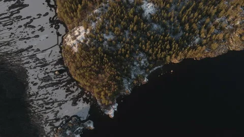 Aerial Reverse Tilt Up Drone Shot Of Half Island On Frozen Lake Sunset Stock Footage 224298382