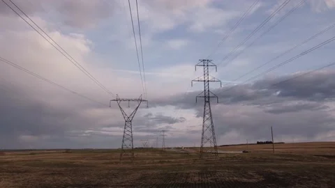 Aerial reverse tracking motion under power lines and transmission towers Stock Footage 195237943