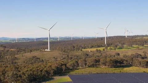 Aerial reverse view of a hybrid solar and wind farm at Bannister, NSW Video stock 288776002