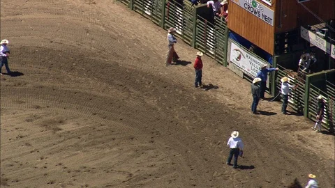 Aerial of riders preparing on racecourse before ride, Rodeo cowboys and horses Stock Footage 109462953