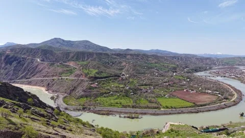 Aerial Rise Over Freight Train Along River With Snowy Mountains Video stock 344744119