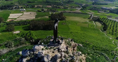 Aerial of Risen Christ statue at atop of hill in Gozo Stock Footage 94926759