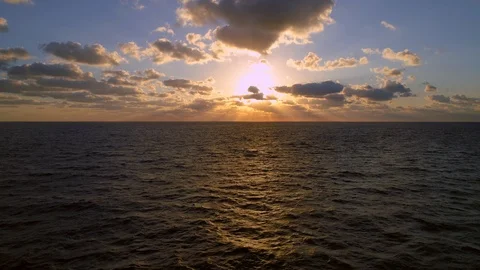 Aerial rising over ocean sunrise god rays Stock Footage