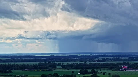 Aerial Rising Shot of Dramatic Storm Clouds Over Jelgava Fields and Forests Stock Footage 313855653