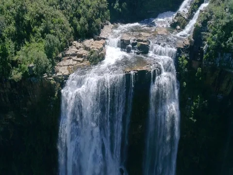Aerial Rising Shot of Waterfall Edge with Rainbows Below Stock Footage 79155336