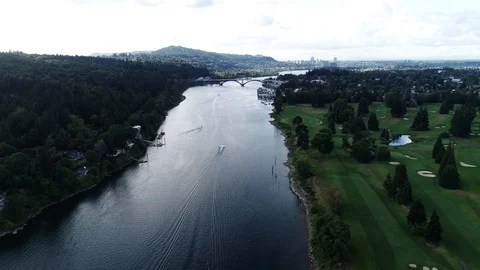 Aerial of river on a cloudy day with trees lining the shore and a golf course Stockbeeldmateriaal 104821379