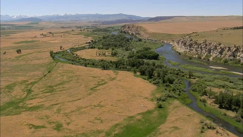 Aerial of river flowing through mountain and grass field, River Stock Footage 109462859