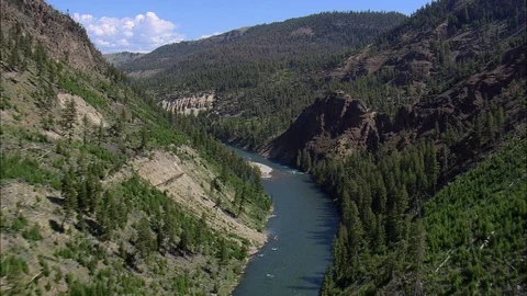 Aerial of river flowing through mountain cliff and forest trees, Idyllic nature Stock Footage 109465782