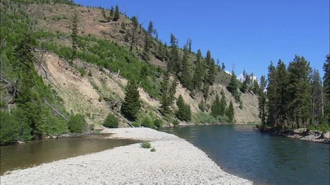 Aerial of river flowing through mountain cliff and forest trees, Yellowstone Stock Footage 109465833