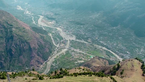 Aerial River Flowing Through Mountain Valley with City Settlement Landscape 库存影片 333032479