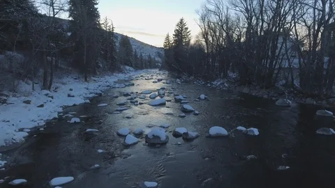 Aerial of river flowing through trees during winter Stock Footage 105482202