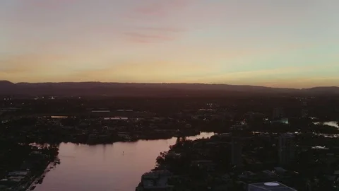 Aerial of river passing through the city settlement during sunset Stock Footage 81008164