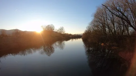 AERIAL River running smoothly at sunset Stock Footage 101076275