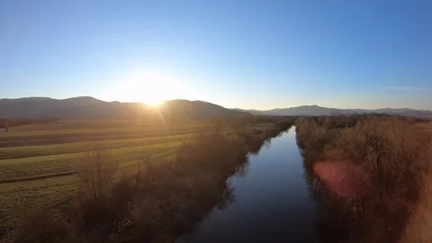 AERIAL Up a river in setting sun Stock Footage 101075648