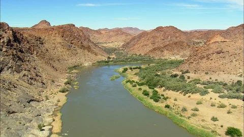 Aerial of river stream flowing through lush green plants, Orange River Stock Footage 109446315