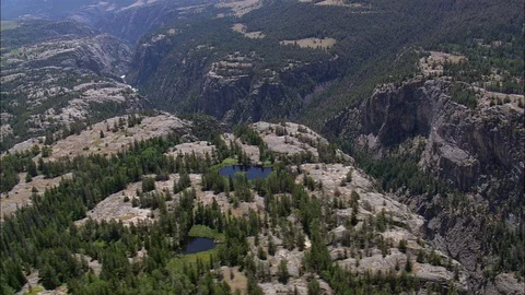 Aerial of river stream flowing through mountain valley, Clarks Fork Yellowstone Stock Footage 109464267
