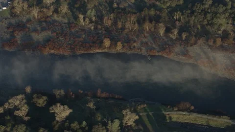 Aerial of river stream in the middle of forest with fields, California Stock Footage 121489876