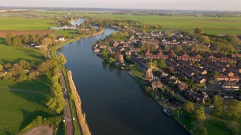 Aerial of river Vecht and two historical dutch windmills in the city of Weesp 스톡 동영상 323007336