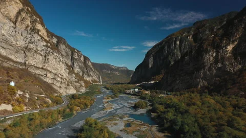 Aerial road between mountains and river  Video stock 171817233