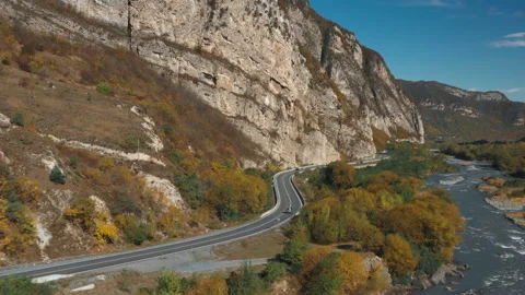 Aerial road between mountains and river  Video stock 171817332