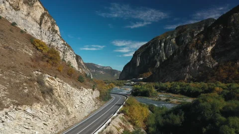 Aerial road between mountains and river  Video stock 171817461