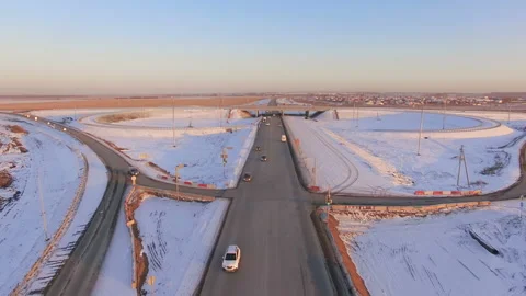 AERIAL:  Road junction under construction during winter sunset. Stock Footage 87011338