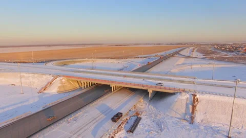 AERIAL:  Road junction under construction during winter sunset. Stock Footage 87012466