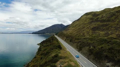 Aerial of road by Mountain Lake Hawea, New Zealand Stock Footage