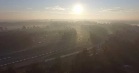 Aerial of road passing through the forest at foggy day Stock Footage 89962885