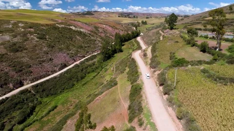Aerial of road passing through patchwork fields on the mountain 스톡 동영상 79678381
