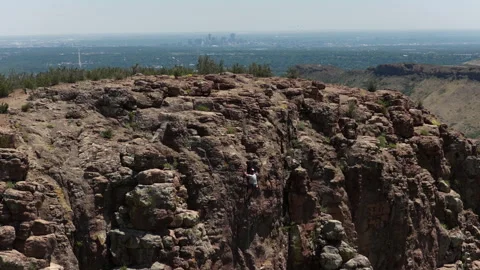 Aerial of rock climber on Table Mountain in Golden Colorado with view of Denver Video stock 337130958